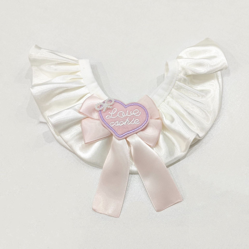 Light Pink ruffled pet neckwear with ribbon tails and heart accent