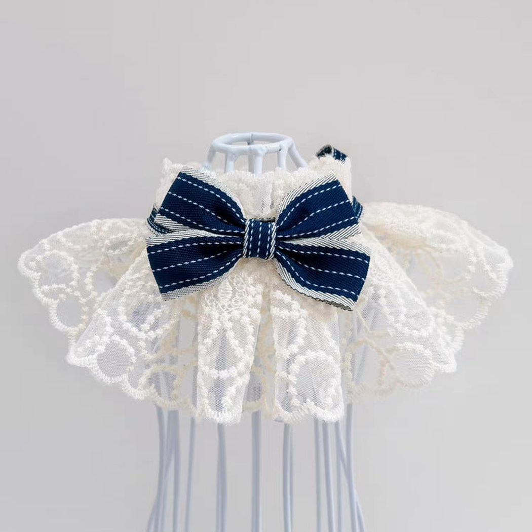Navy pet neckwear with layered lace-look ruffles and striped bow