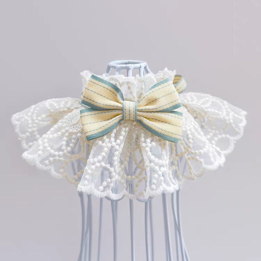 Yellow pet neckwear with layered lace-look ruffles and blue-green bow accents