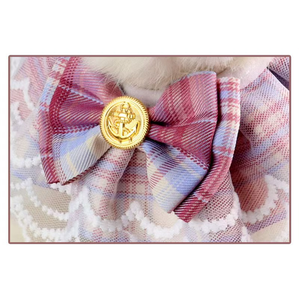 Close-up of the plaid bow and gold-tone anchor medallion