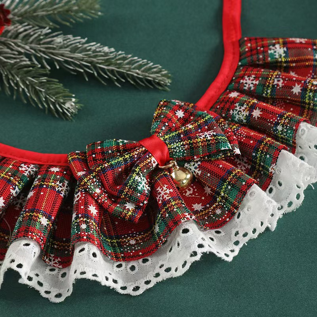 Close-up of the plaid bow, gold-tone bell and white eyelet trim