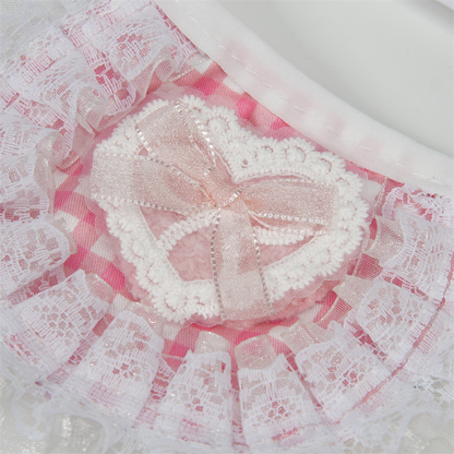 Close-up of the layered heart applique and bow on pink gingham pet neckwear