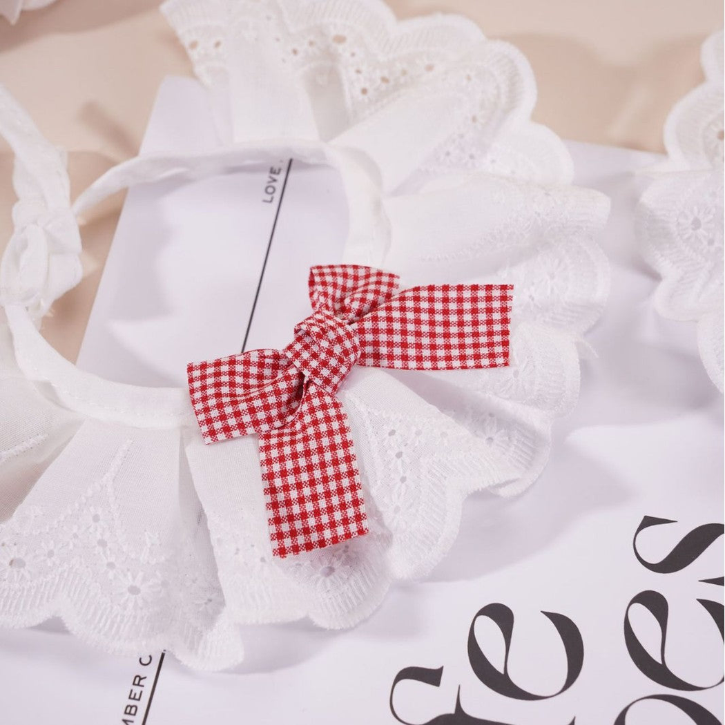 Close-up of the Red gingham bow and scalloped eyelet-style ruffle