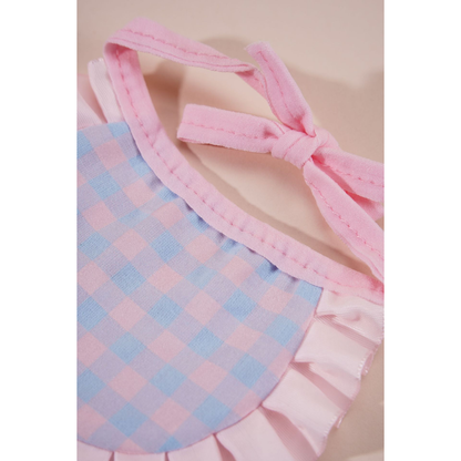 Close-up of the pink tie straps, stitched neckline and checked reverse panel