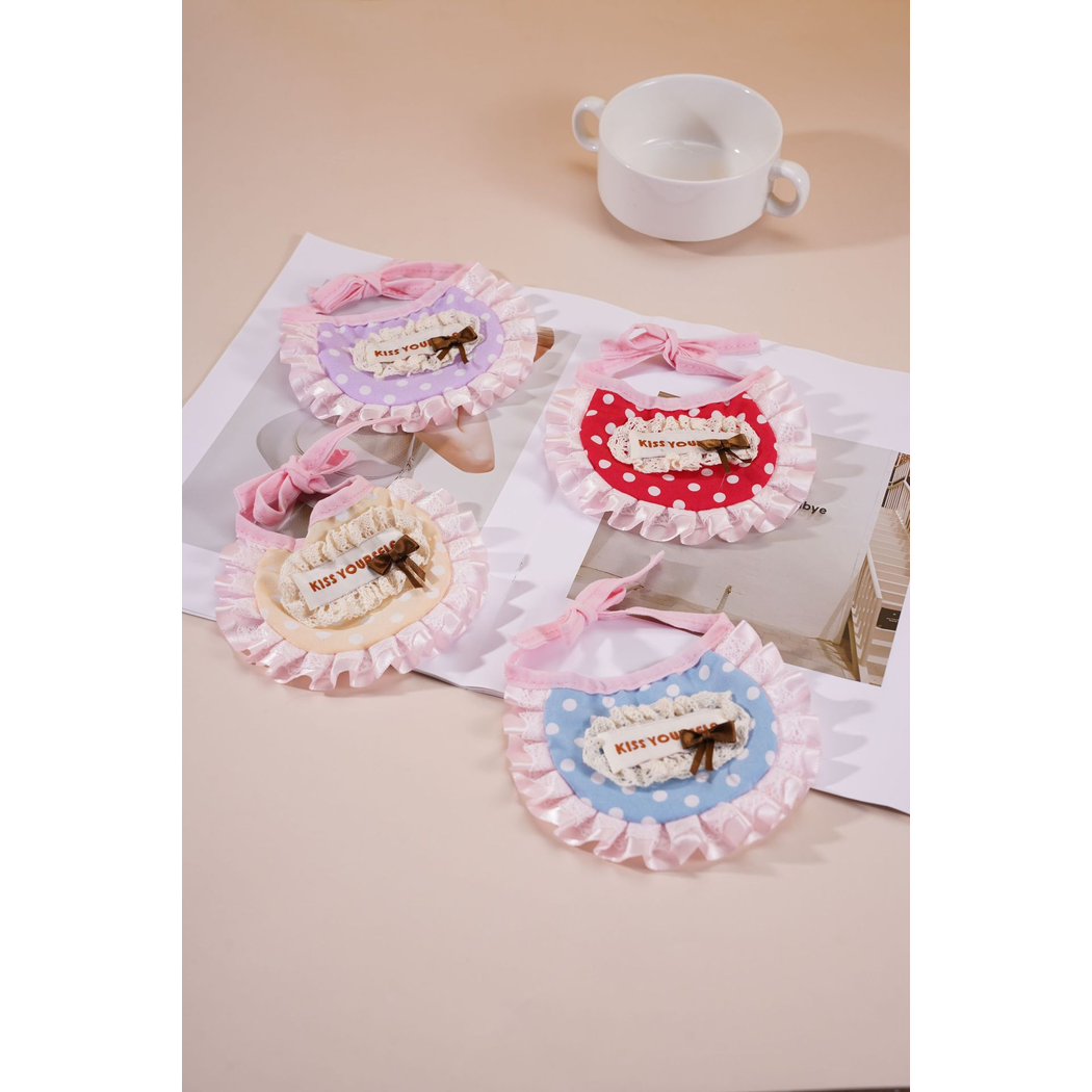 Four polka-dot pet neckwear colors arranged in a tabletop display