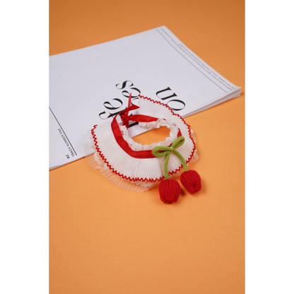 Red pleated pet neckwear with green bow and dangling tulip-shaped ornaments
