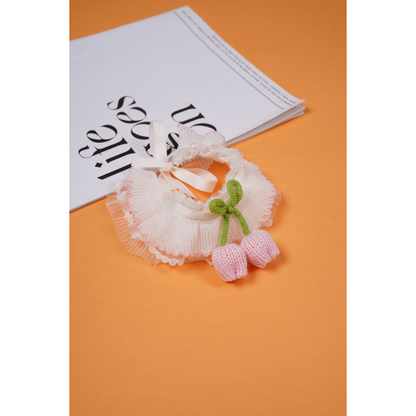 Light pink pleated pet neckwear with green bow and dangling tulip-shaped ornaments
