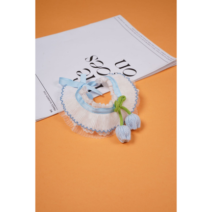 Light blue pleated pet neckwear with green bow and dangling tulip-shaped ornaments