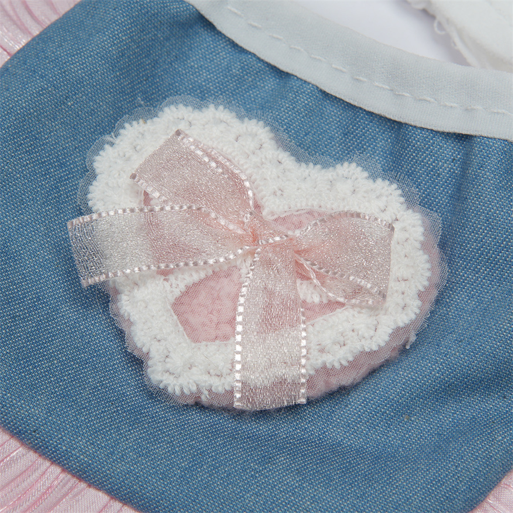 Close-up of the heart decoration and pink ribbon bow on blue pet neckwear