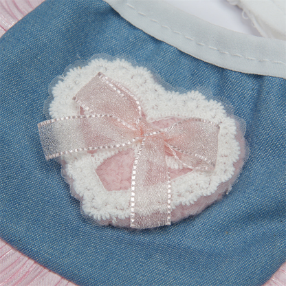 Close-up of the heart decoration and pink ribbon bow on blue pet neckwear