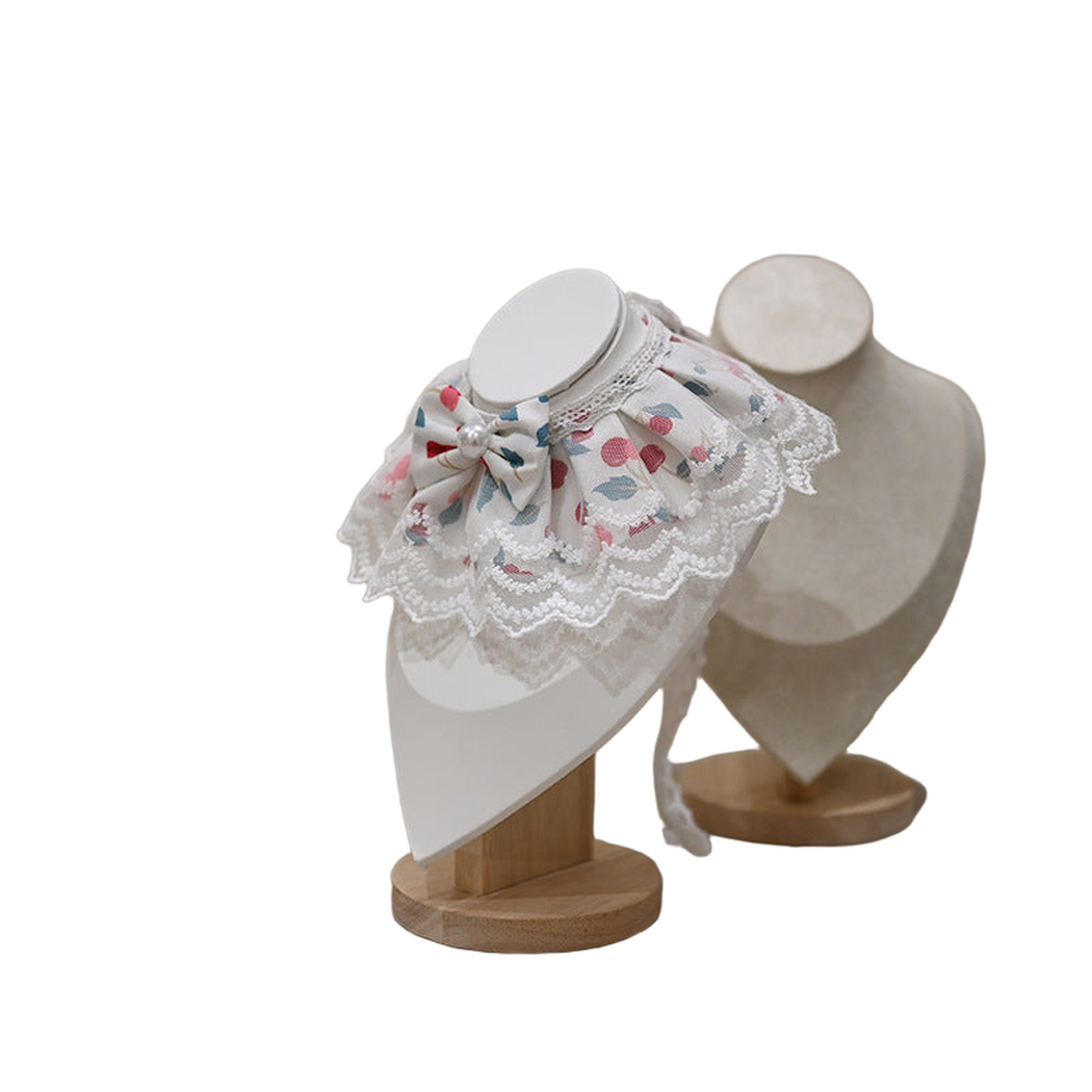 Cherry pet neckwear with layered lace-look edging, angled view