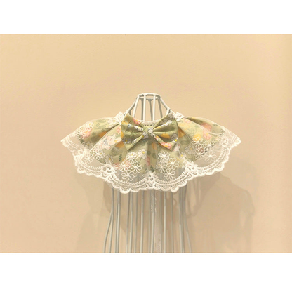 Green floral Pet Neckwear with white lace-look trim and a centered bow, front view