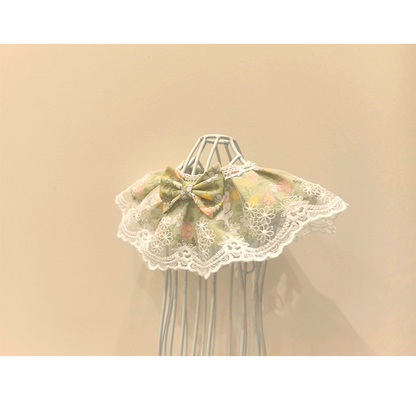 Green floral Pet Neckwear with scalloped lace-look trim, angled front view