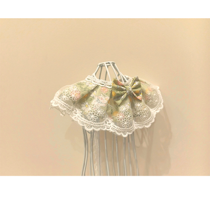 Green floral Pet Neckwear with a front bow and white floral lace-look overlay, three-quarter view
