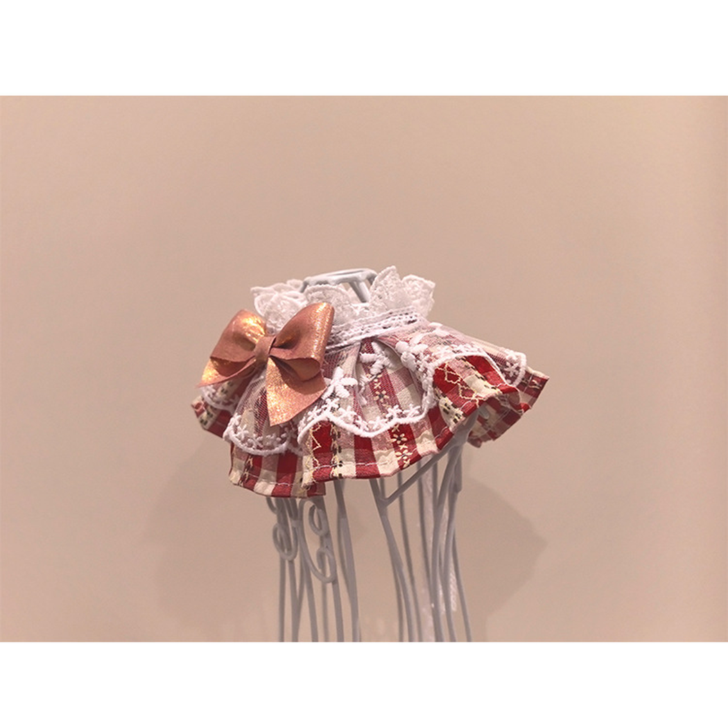 Red plaid pet neckwear with layered lace-look ruffles and a metallic pink bow, angled side view