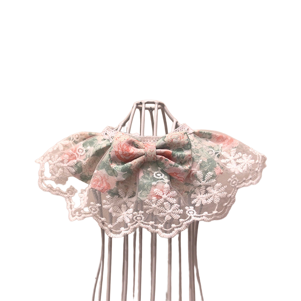 Floral pet neckwear with centered bow and white lace-look edging, front view