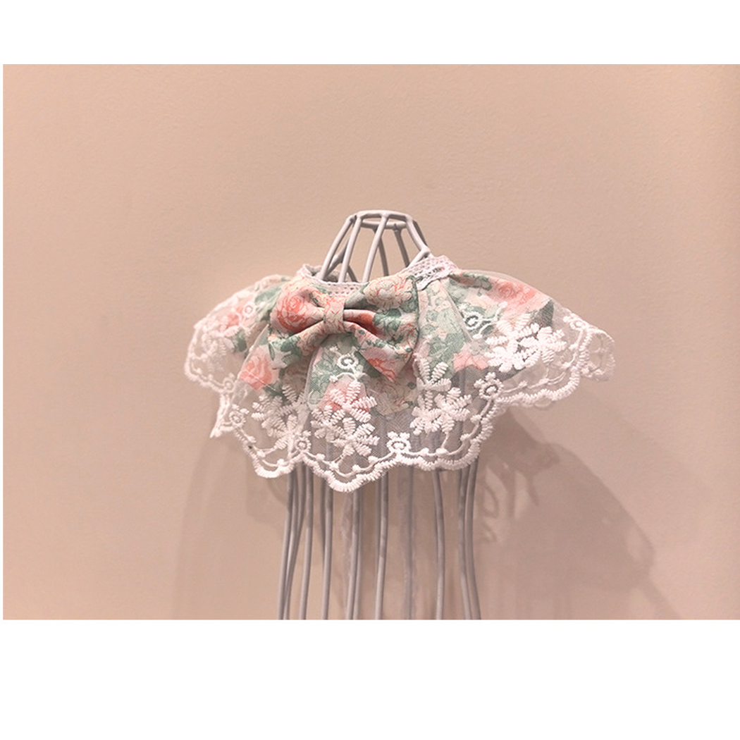Floral pet neckwear with centered bow and embroidered lace-look edge, opposite angled view