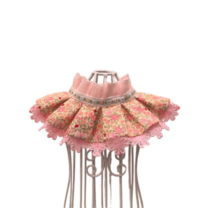 Pink floral pet neckwear with ruffled neckline and lace-look trim, front view