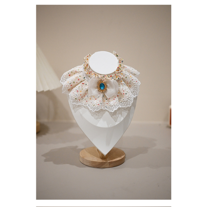 Jewel pet neckwear with confetti-dot ruffles and a blue jewel-look centerpiece, front view