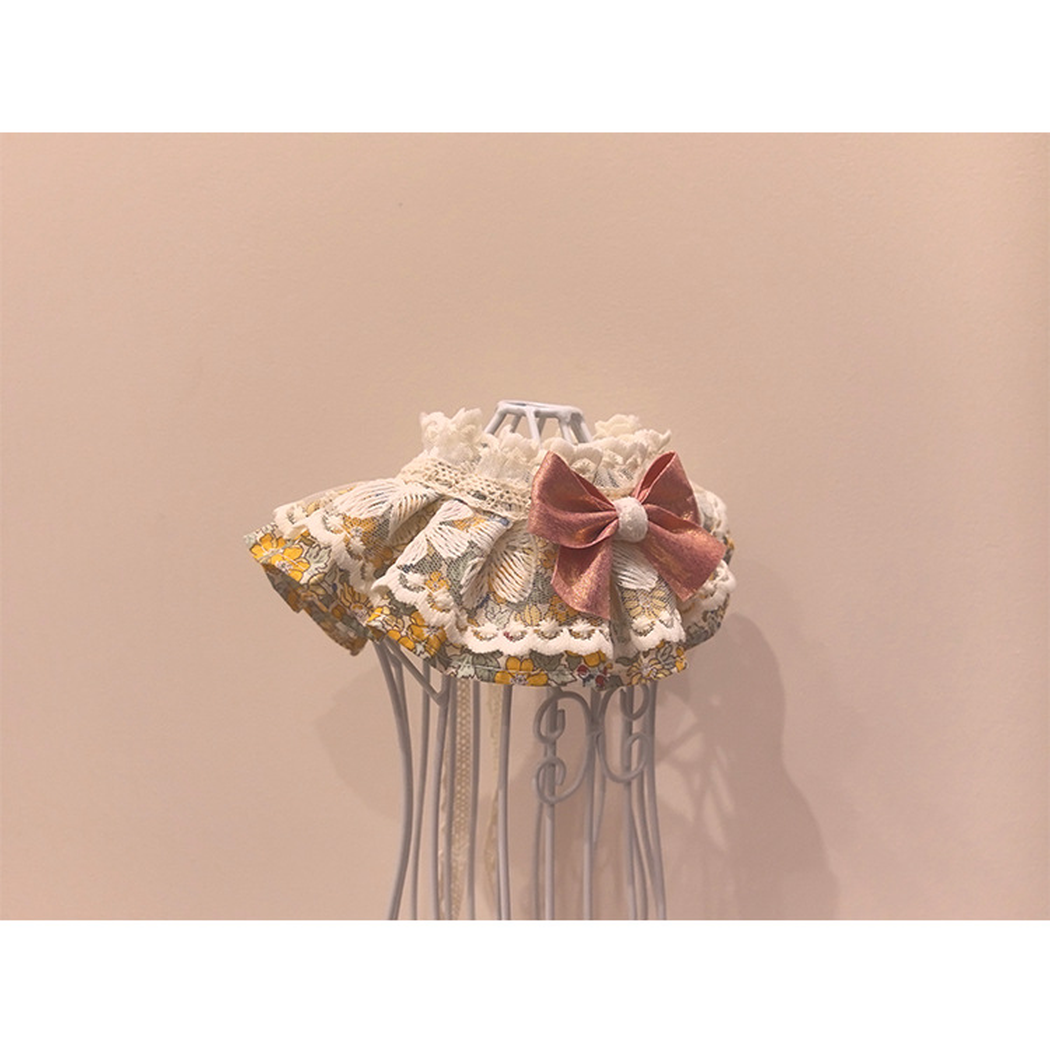 Floral pet neckwear with lace-look trim and rose-pink bow, angled view