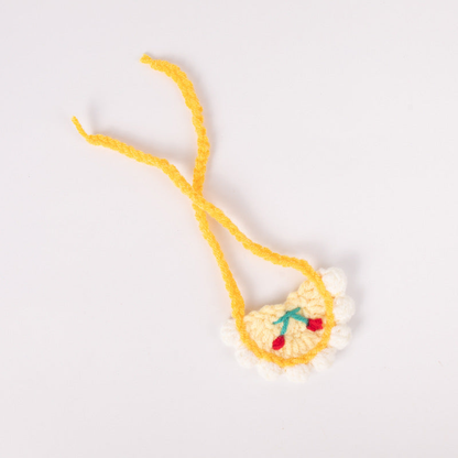 White pet neckwear with yellow trim and cherry motif, flat view