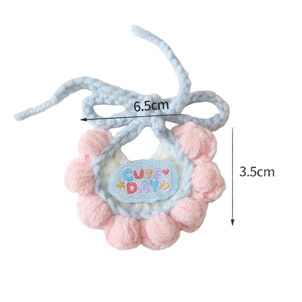 Pink pet neckwear with light blue trim and scalloped edge, measured flat