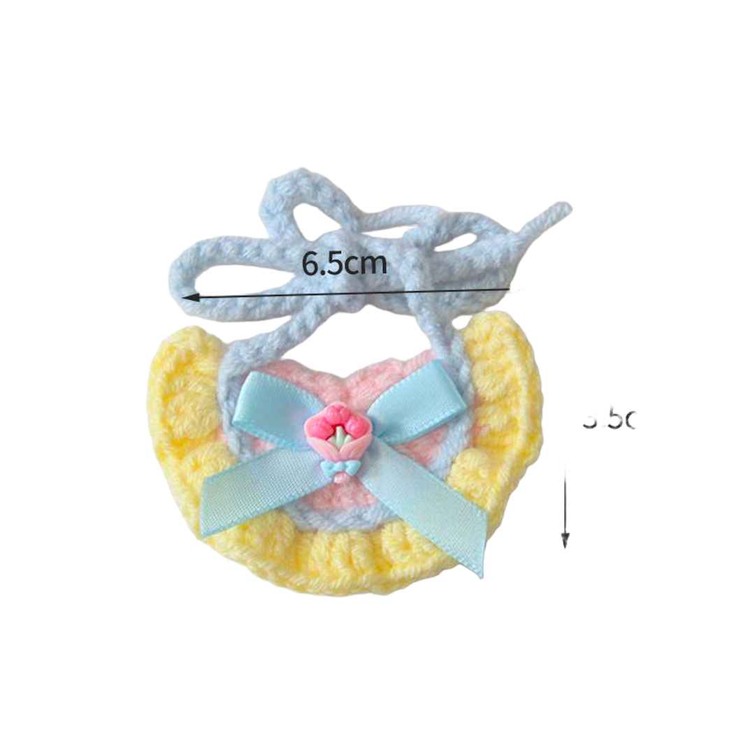 Yellow pet neckwear with light blue bow and small flower accent, measured flat