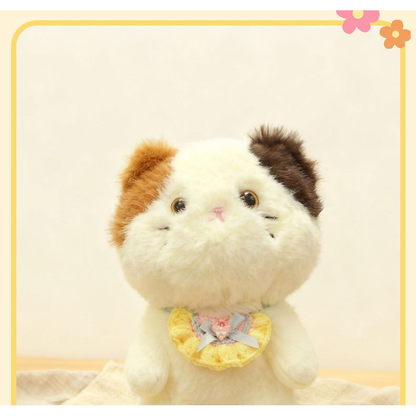 Yellow pet neckwear with blue bow displayed on a plush cat figure