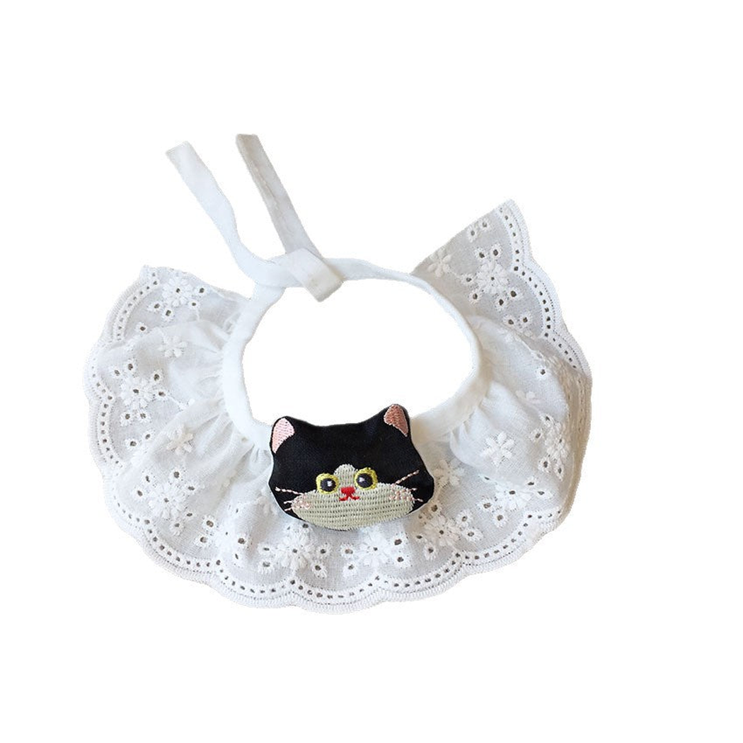 Black cat-face pet neckwear with a white ruffled eyelet-look bib, front view