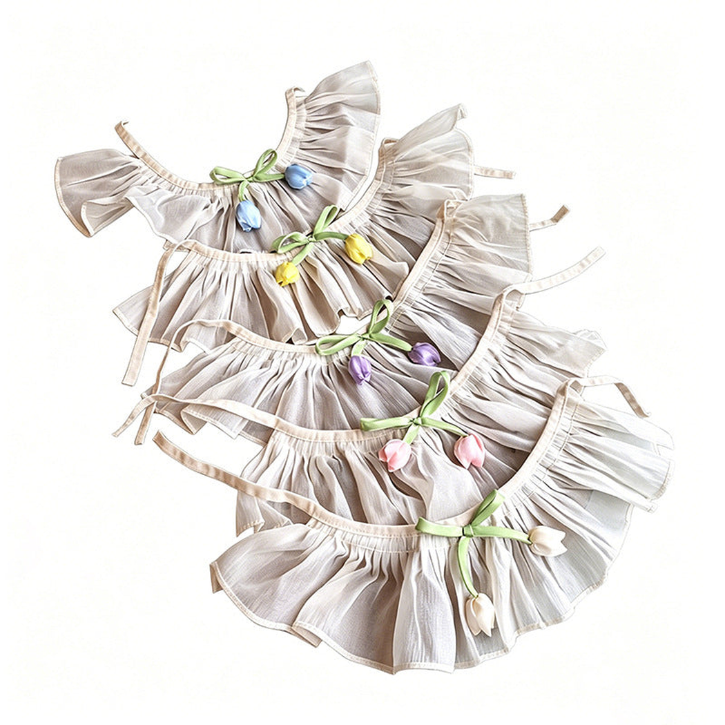 Assorted tulip pet neckwear arranged flat to show gathered ruffles and tie straps