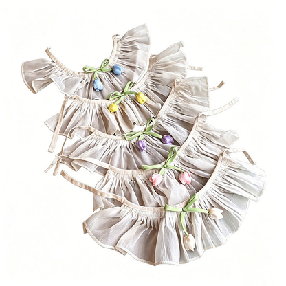 Assorted tulip pet neckwear arranged flat to show gathered ruffles and tie straps