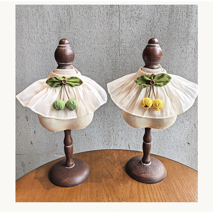 Green Cherry and Yellow Cherry pet neckwear displayed together on stands