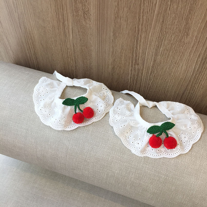 Two sizes of white cherry-accent pet neckwear displayed side by side
