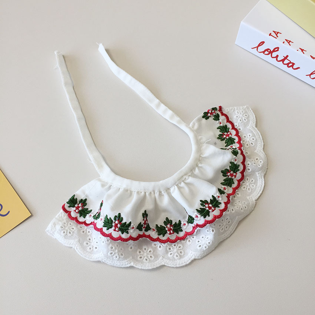 Floral pet neckwear laid flat with extended tie straps and layered white trim