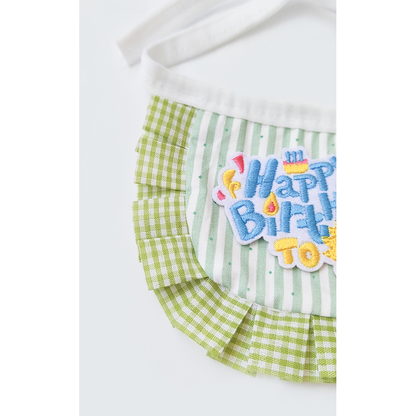 Close-up of green stripes, gingham ruffle and embroidered birthday message