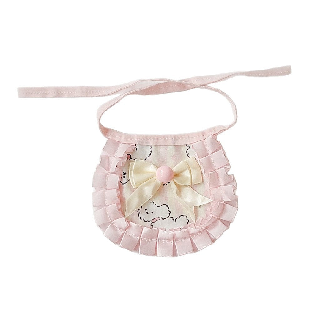 Pink ruffled pet neckwear with cream bow and playful dog motif