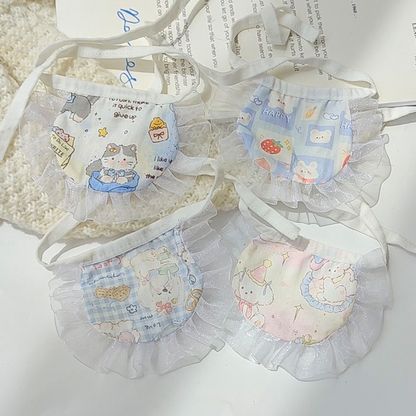 Four pastel cartoon-print pet neckwear styles arranged with their white ruffled borders and tie straps visible