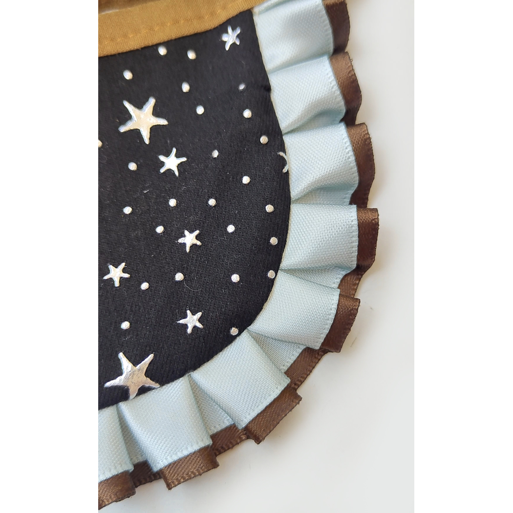 Close-up of the star-and-dot pattern and layered pleated ruffle