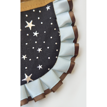 Close-up of the star-and-dot pattern and layered pleated ruffle