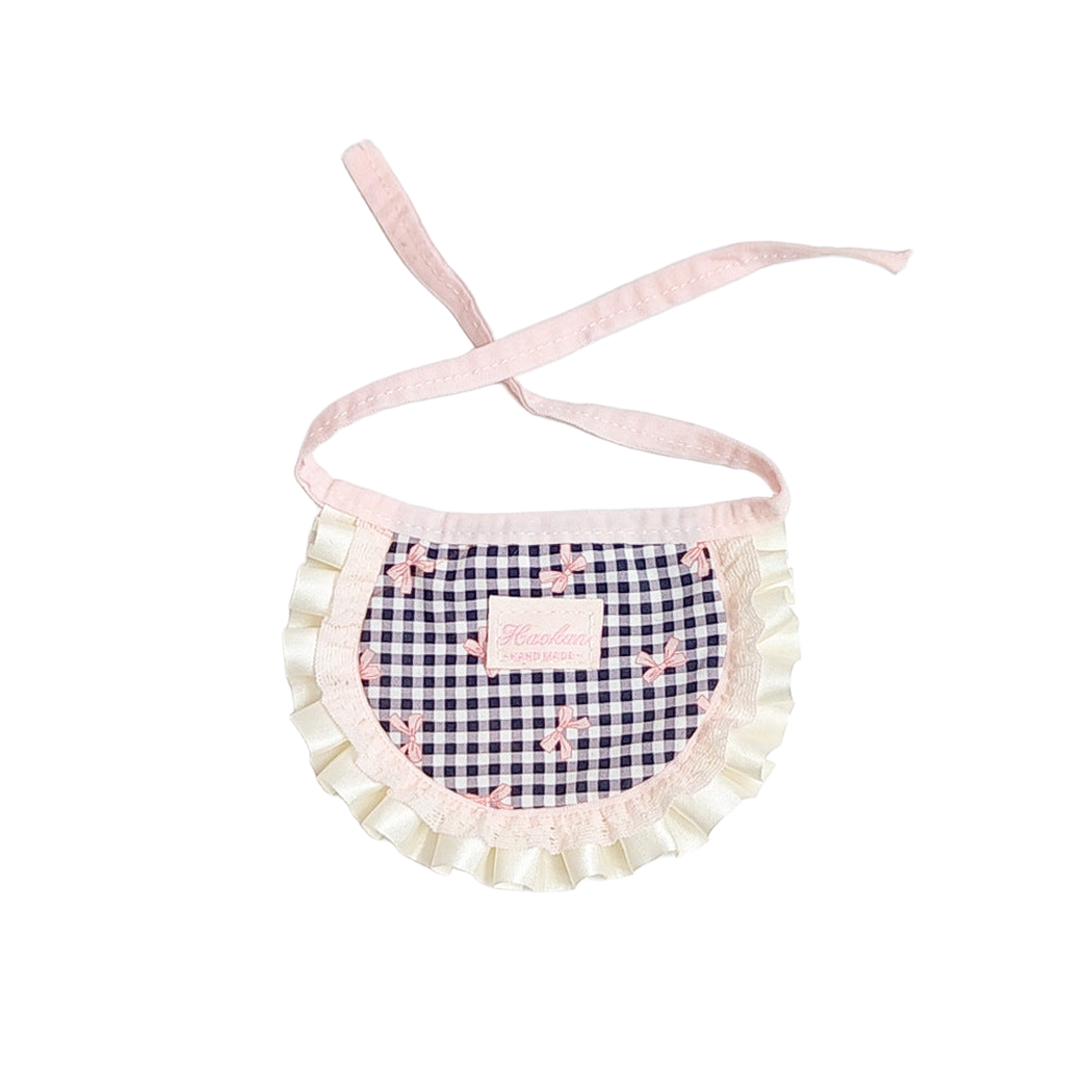 Cream gingham bib-style pet neckwear with bow motifs and ruffled trim