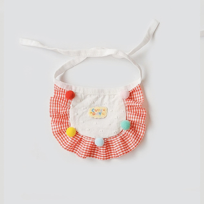 Red gingham pet neckwear with ruffled border and colorful pom-poms