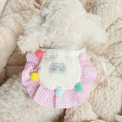 Pink gingham pet neckwear worn by a white dog