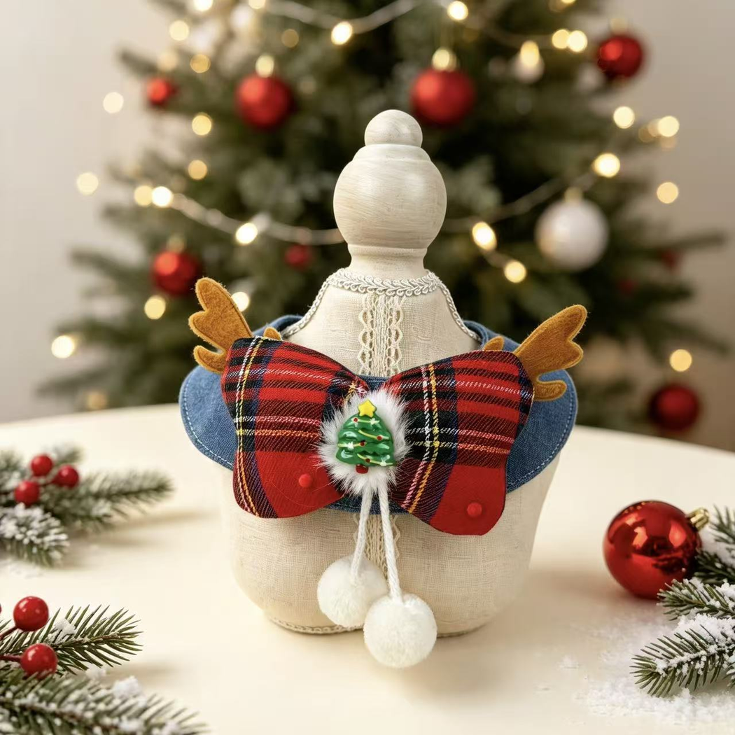 Red tartan bow pet neckwear displayed on a dress form with festive decorations