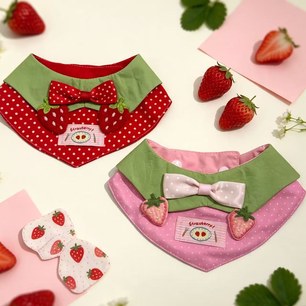 Red and pink strawberry pet neckwear displayed together