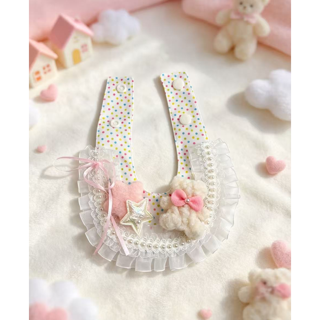 Decorative pet neckwear laid open with snap straps and layered ruffled trim