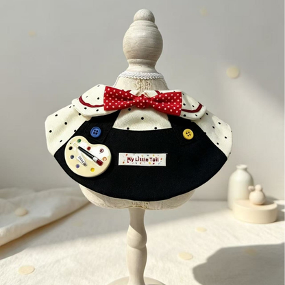 Artist-themed pet neckwear displayed on a decorative stand, close view
