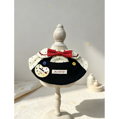Artist-themed pet neckwear displayed on a full decorative stand
