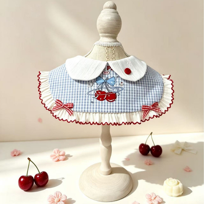 Cherry-pattern pet neckwear displayed on a decorative stand