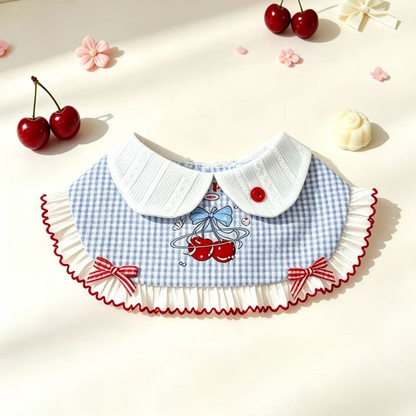 Cherry-pattern pet neckwear arranged in a decorative flat lay