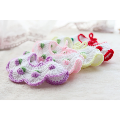 Four pet neckwear styles arranged diagonally to show their layered scalloped shapes